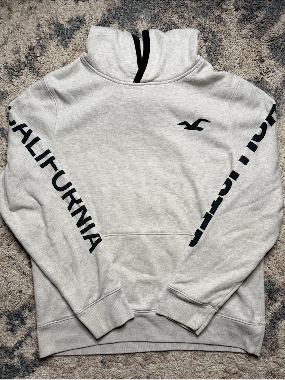 Hollister Cream Hoodie with Black Sleeve Text and Logo Accent